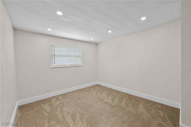 carpeted empty room with recessed lighting and baseboards