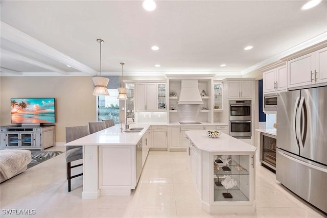 kitchen featuring custom exhaust hood, open shelves, appliances with stainless steel finishes, a sink, and a peninsula