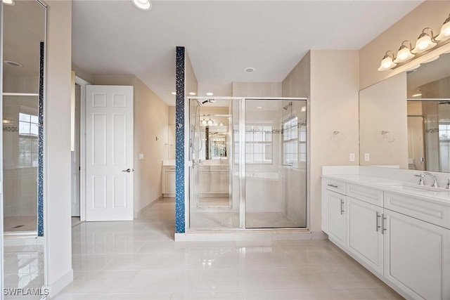 bathroom featuring tile patterned floors, a shower stall, and vanity