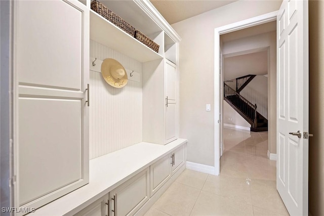 mudroom with light tile patterned floors and baseboards