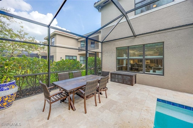 view of patio / terrace with outdoor dining area and a lanai