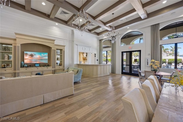 living room with visible vents, coffered ceiling, wood finished floors, an inviting chandelier, and french doors