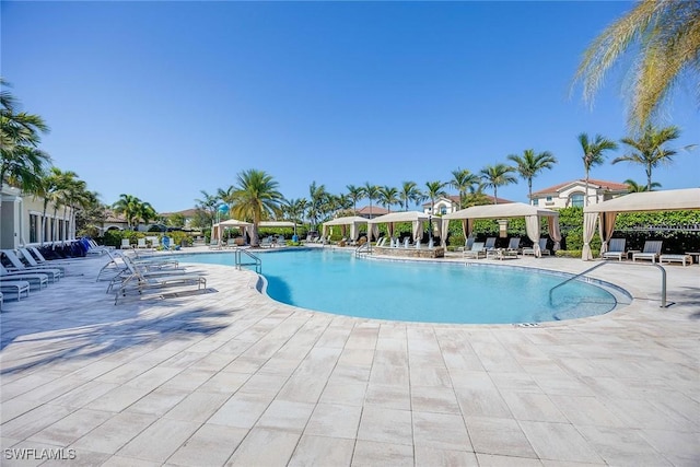 community pool with a gazebo and a patio