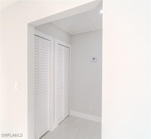 interior space featuring light tile patterned floors and baseboards