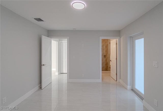 unfurnished room featuring visible vents and baseboards