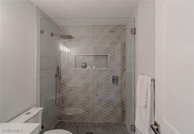 bathroom featuring toilet, a shower stall, and vanity