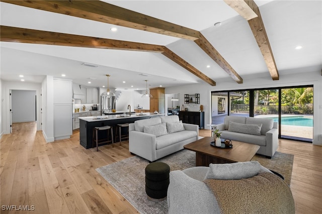 living room featuring visible vents, recessed lighting, lofted ceiling with beams, and light wood-style floors