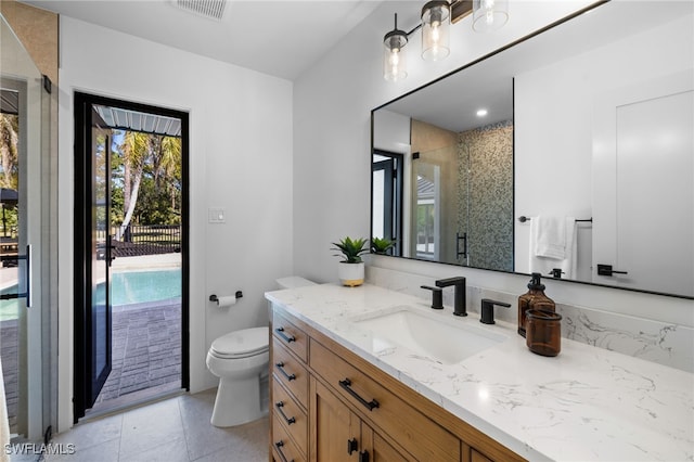 bathroom featuring vanity, toilet, a healthy amount of sunlight, and a stall shower