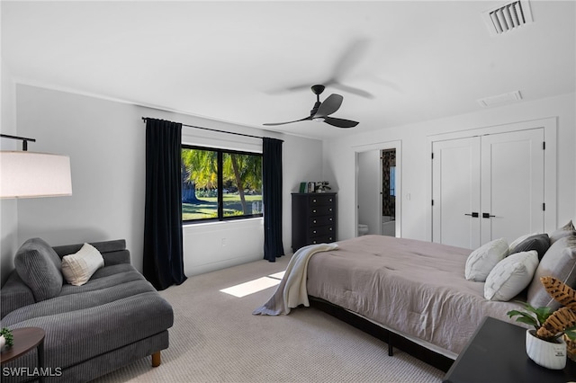 carpeted bedroom with visible vents and ceiling fan