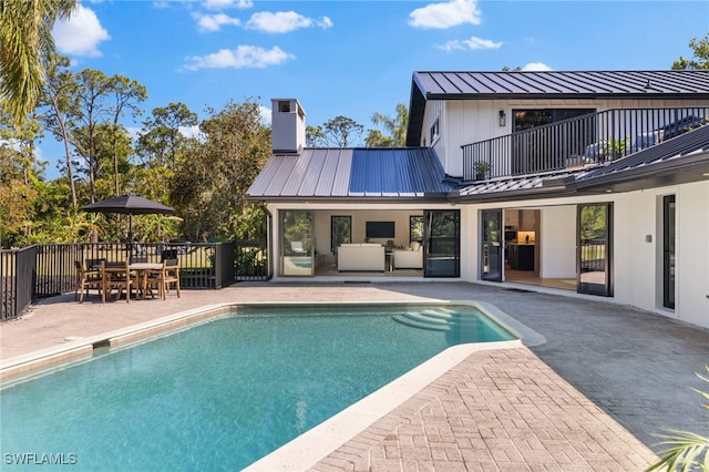 view of swimming pool with a fenced in pool, an outdoor hangout area, outdoor dining area, and a patio area