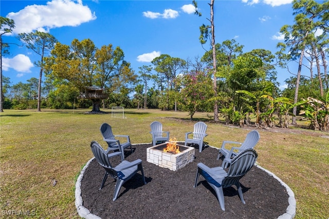 view of yard with a fire pit