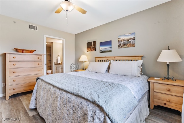 bedroom featuring ceiling fan, ensuite bath, wood finished floors, and visible vents