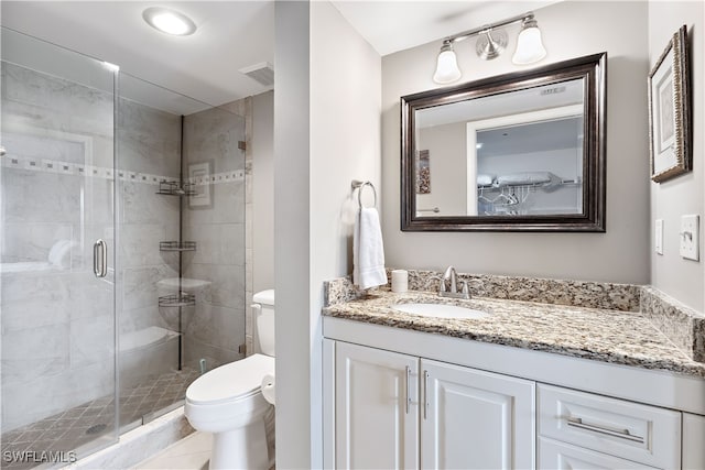 bathroom featuring visible vents, a stall shower, vanity, and toilet