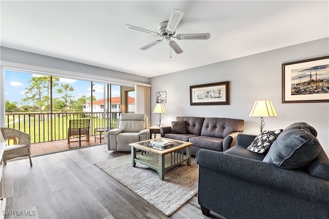 living room featuring ceiling fan and wood finished floors