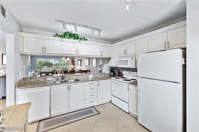 kitchen featuring white cabinetry, a sink, light tile patterned flooring, light stone countertops, and white appliances