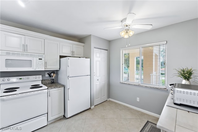 kitchen featuring light tile patterned floors, a ceiling fan, white cabinetry, white appliances, and baseboards