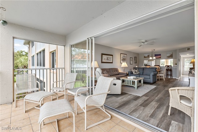 sunroom with ceiling fan