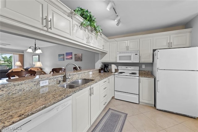 kitchen with white appliances, light tile patterned floors, white cabinets, and a sink