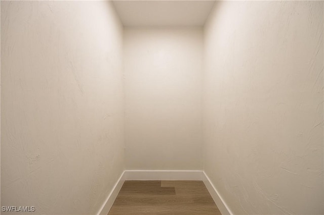 interior space with wood finished floors and baseboards