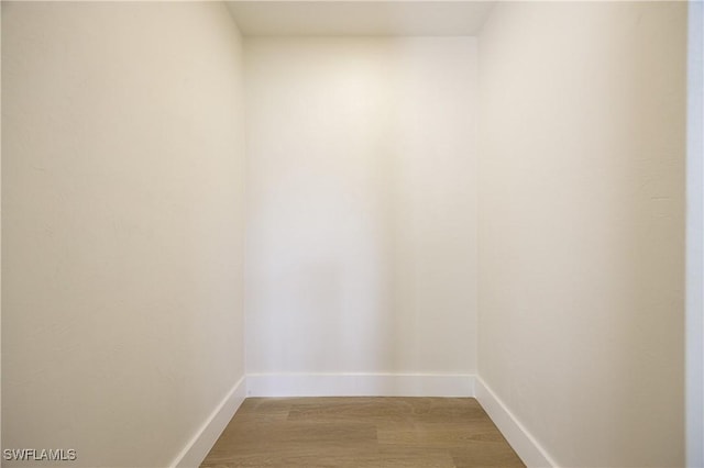 interior space featuring baseboards and wood finished floors