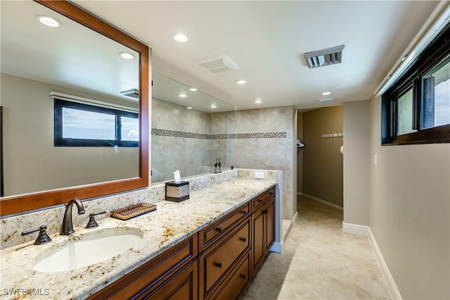 720 S Collier Blvd Unit 1007, Marco Island, FL 34145 - full bath with vanity, recessed lighting, baseboards, plenty of natural light, and tile patterned floors