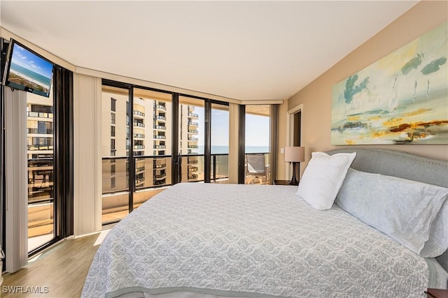 720 S Collier Blvd Unit 1007, Marco Island, FL 34145 - bedroom with access to outside, floor to ceiling windows, and wood finished floors