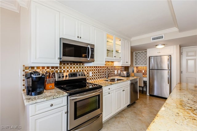720 S Collier Blvd Unit 1007, Marco Island, FL 34145 - kitchen with appliances with stainless steel finishes, a sink, white cabinetry, tasteful backsplash, and ornamental molding