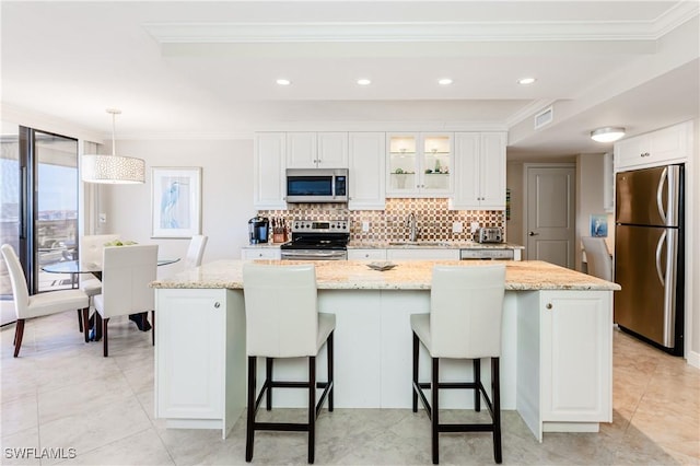 720 S Collier Blvd Unit 1007, Marco Island, FL 34145 - kitchen with appliances with stainless steel finishes, a sink, decorative backsplash, ornamental molding, and white cabinets