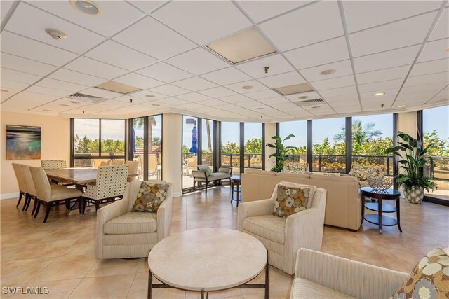 720 S Collier Blvd Unit 1007, Marco Island, FL 34145 - living room with expansive windows, light tile patterned floors, a drop ceiling, and baseboards