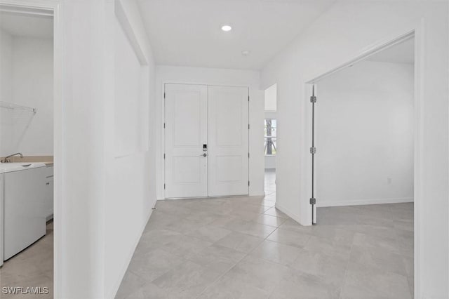 entryway featuring washer / clothes dryer and baseboards