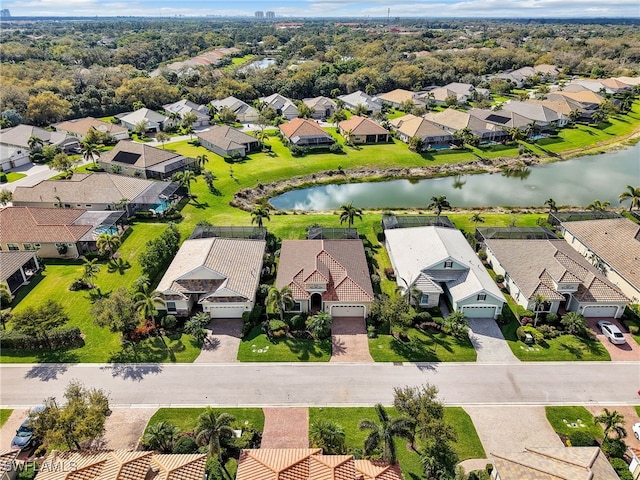 drone / aerial view with a water view and a residential view