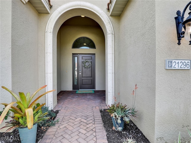 doorway to property with stucco siding