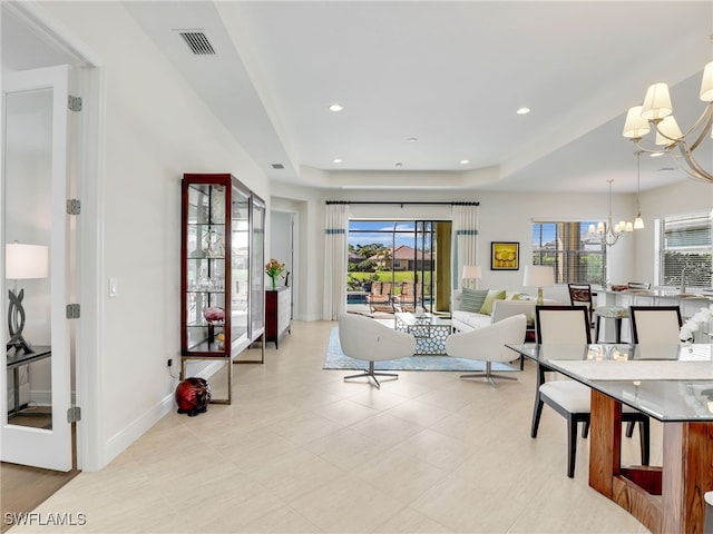 interior space with recessed lighting, a healthy amount of sunlight, a notable chandelier, and visible vents