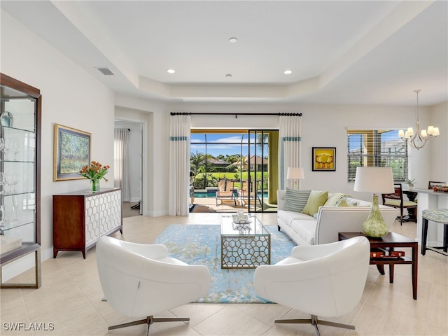 living area featuring baseboards, recessed lighting, and an inviting chandelier