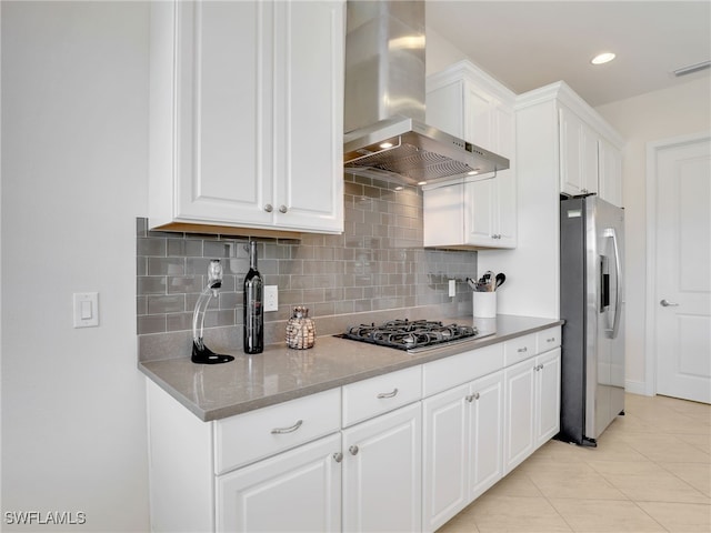 kitchen with visible vents, white cabinetry, gas cooktop, ventilation hood, and stainless steel fridge with ice dispenser