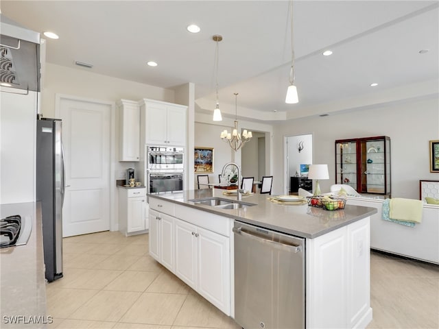 kitchen with visible vents, open floor plan, a sink, stainless steel appliances, and a notable chandelier