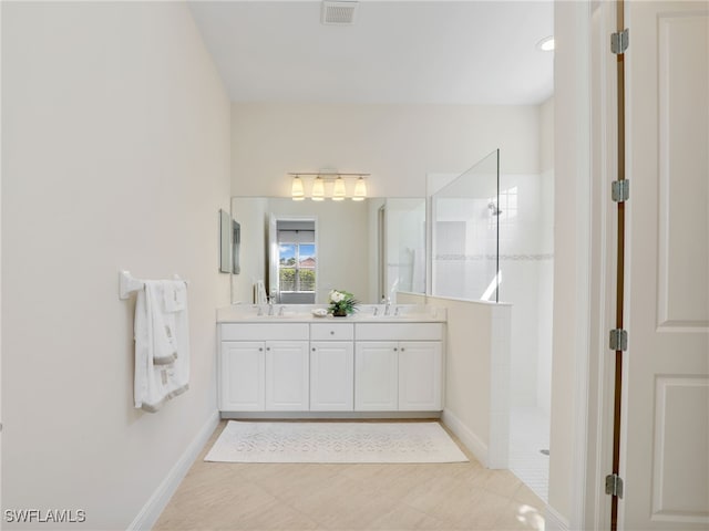 full bathroom with a walk in shower, a sink, visible vents, baseboards, and double vanity