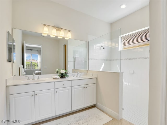 full bath with a walk in shower, double vanity, a sink, and connected bathroom