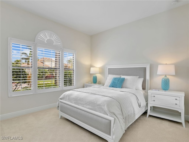 carpeted bedroom featuring baseboards