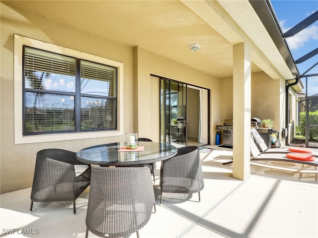 view of patio / terrace with a lanai and outdoor dining area