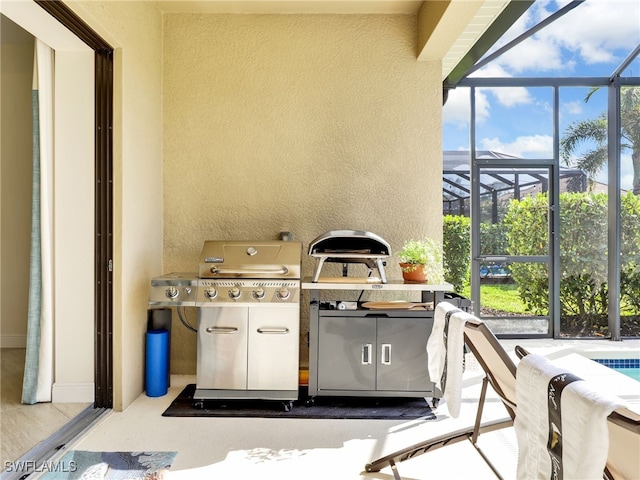 view of patio with a lanai and a grill