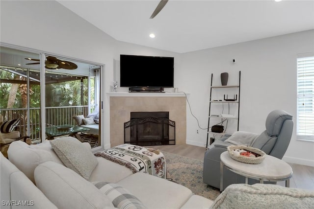 living area featuring ceiling fan, vaulted ceiling, plenty of natural light, and wood finished floors