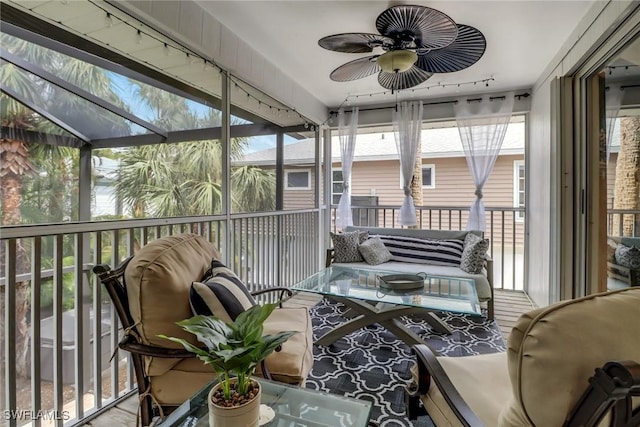 sunroom / solarium with rail lighting and ceiling fan