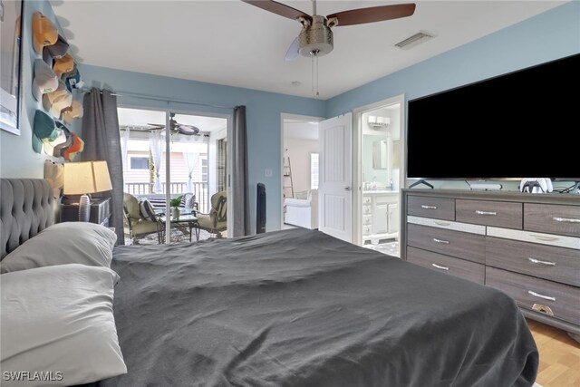 bedroom featuring wood finished floors, visible vents, a ceiling fan, access to outside, and ensuite bath