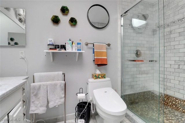 full bathroom featuring a stall shower, vanity, and toilet