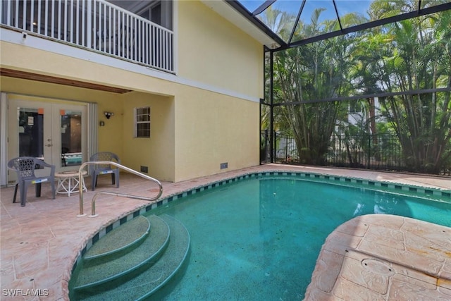 pool featuring a lanai, a patio, and french doors