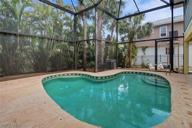 pool featuring a lanai and a patio area