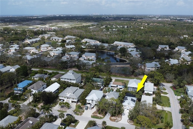 drone / aerial view with a water view and a residential view