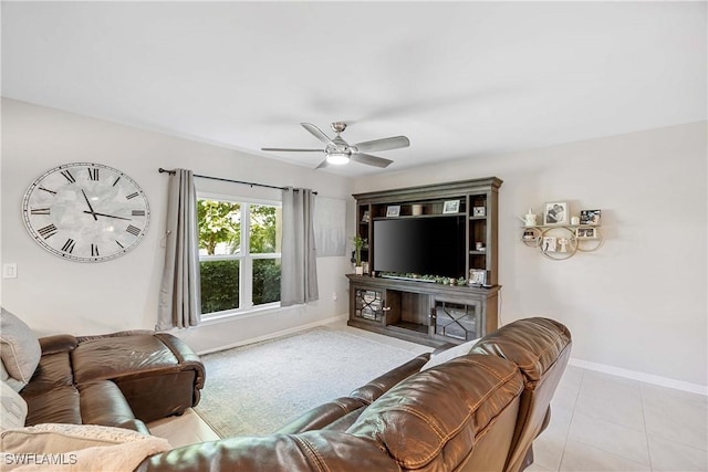 living room with light tile patterned floors, ceiling fan, and baseboards