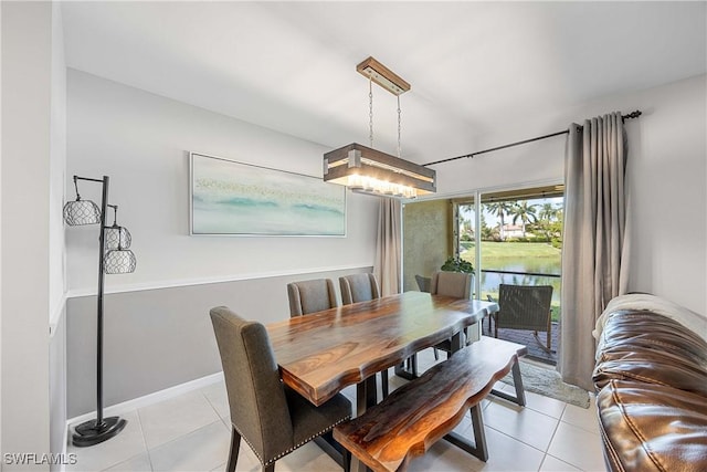 dining room with light tile patterned flooring and baseboards